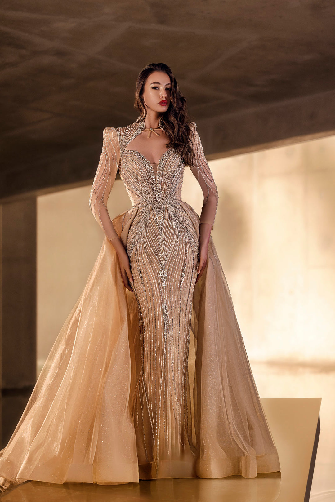 Delilah LD11650 High Collar Long Sleeve Crystal Sheath Gown with Tulle Overskirt - Champagne front view
